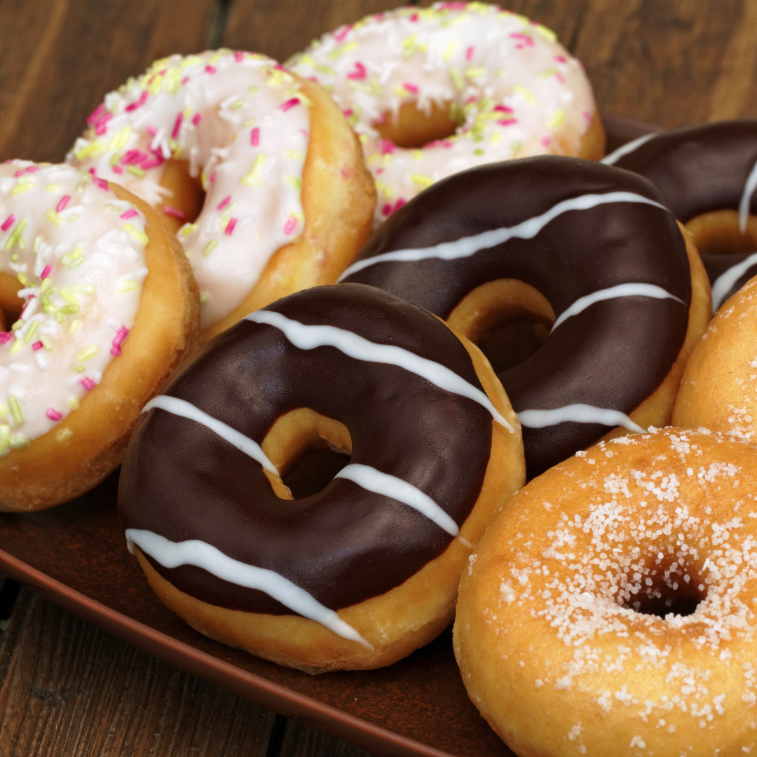 A selection of iced and sugared doughnuts.